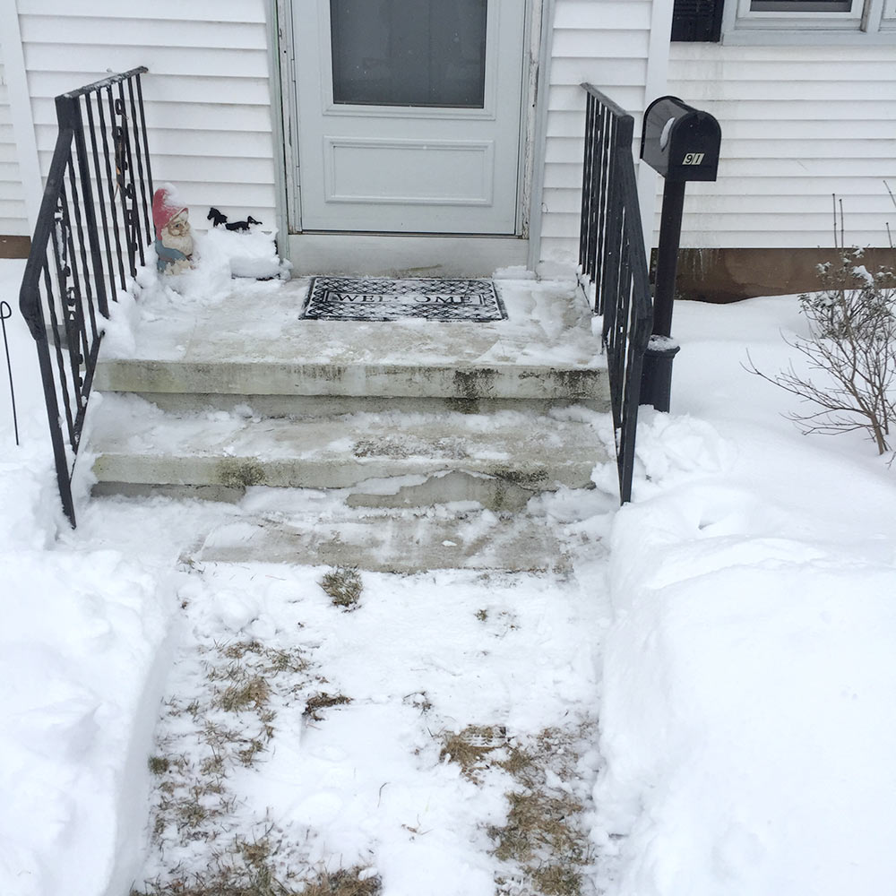 Wayne Mingle clear snow off the steps and walkway for his elderly neighbors.